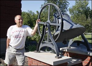 Bill Strayer rings the school bell. It had been rung at the school from 1914-1951.