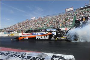 Top Fuel racer Spencer Massey performs a burnout prior to capturing his fourth victory of the season.