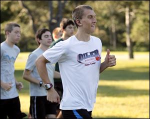  Bryant Byrd, a member of the Perrysburg High School cross country team, runs with the River Runners club in Side Cut Metrotrpark in Maumee.