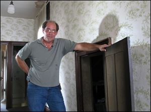 Karl Kissner stands next to the attic door of his grandfather's house in Defiance, where some 700 vintage, and extremely valuable baseball cards were discovered.