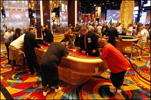 Gamblers ring craps tables at Hollywood Casino Toledo. The site run by Penn National Gaming has generated about $7.5 million in tax revenue for school districts and government entities across the state of Ohio.