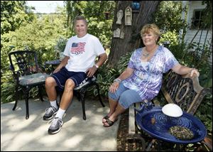 Ken and Julie Peace enjoy their backyard garden at their home on Gribbin Lane Tuesday.