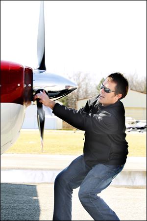 Flight student Don Coburn, from Sylvania, does a preflight check on a Cessna 182 before proceeding with Instrument flight rules (IFR) training with Suburban Aviation, Inc. Flight Instructor Nick Zink.