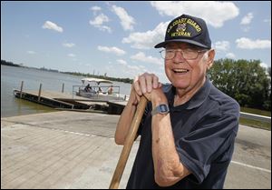 Jim Chamberlin takes a break from cleaning debris from the boat ramp at Walbridge Park. The 86-year-old is a retired boat-builder. 
