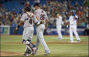 Cleveland Indians pitcher Derek Lowe, right, talks with catcher Carlos Santana during third inning Sunday in Toronto. The Indians lost 3-0 to the Blue Jays.