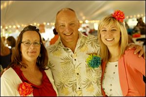 From left, Kelly Brooks, Harry Cummins, and Jackie Zureich pose during the Chicks for Charity Chicks Mix. 