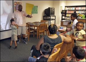Instructor William White and Elmer Valquez lead a discussion of the day’s book in the Kidz!Lit class as part of the summer program at Reynolds.