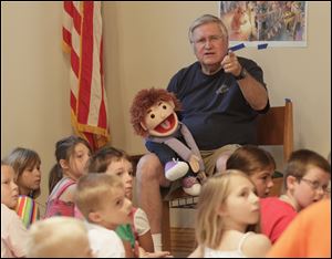 Pastor Doug Meilander and his friend Alex make a point during the vacation Bible school class at Concordia Lutheran Church in Toledo. More than 60 children attended last week’s sessions.