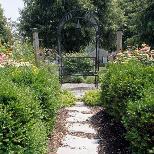 A-bench-at-the-end-of-a-walk-in-the-garden