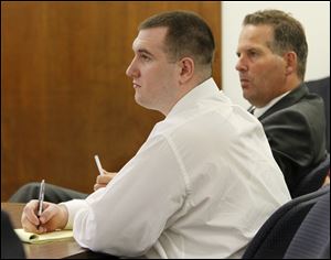 Defense attorneys Jane Roman, left, and John Thebes flank Samuel Williams, 24, of East Toledo as the prosecution describes its case in Lucas County Common Pleas Court.