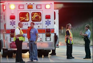Police at the scene of a fatal accident where a car struck three pedestrians on Miami Street near the Days Inn.