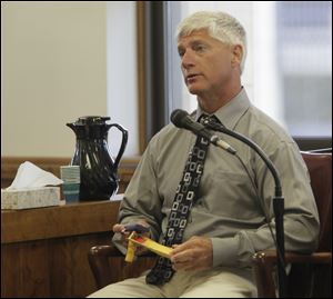 Jeff Straub, father of Lisa Straub, with a non-functioning garage opener from the house.