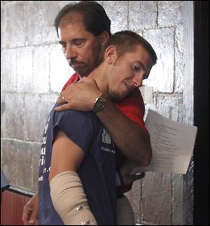 the blade/amy e. voigtGage Hankins, 18, is embraced by his uncle John Massara after speaking to reporters in Forest, Ohio.