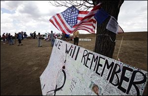 A U.S. flag flies above a message board that reads 