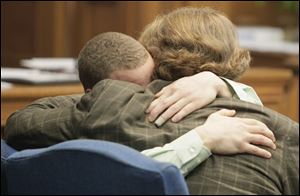 Cameo Pettaway, left, embraces Merle Dech, one of his attorneys, after Common Pleas Judge James Bates dismissed all charges. The judge said Thursday evidence was not sufficient for conviction.