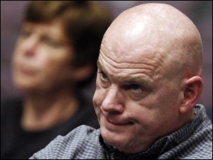 Warren Brown of Clyde, Ohio, listens during  a public meeting about the   investigation into childhood cancer in the Clyde area, Dec. 16, 2008, in Clyde, Ohio. Brown's 11-year old daughter, Alexa, died of cancer in 2009.