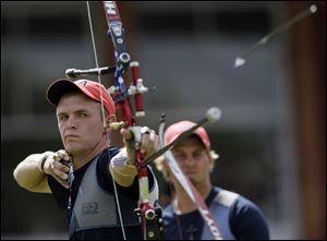 Brady Ellison, left, Jake Kaminski, and Jacob Wukie show off their silver medals in London. The U.S. teammates said they plan to store them in their sock drawers. The individual men's archery competition begins Tuesday.