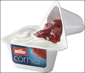 Muller by Quaker yogurt containers are square, with one corner filled with fruit flavors, carmelized almonds, chocolate-covered
crunch balls, or granola. The consumer adds the ingredient to the yogurt and mixes it in.