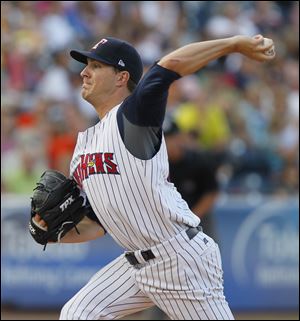 Toledo Mud Hens pitcher Adam Wilk fires in a shot against the Louisville Bats in the first inning at Fifth Third Field, Saturday.