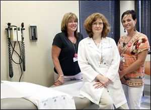 Joan Duggan, center, a physician at UT Medical Center, is not convinced that Oraquick will make a dent in infection rates. With her are staff members Christie Clinton, left, and Michelle Coutcher.