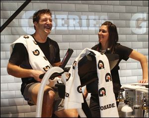 Former Florida Gators quarterback Tim Tebow, left, laughs with Gatorade scientist Melissa Tippet after a caloric expenditure test at the Gatorade Performance Lab. A recent survey of the performance-enhancing claims made for dozens of fitness products, researchers found not a single one that could be supported by rigorous scientific research.