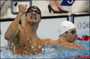 Nathan Adrian celebrates his Olympic gold medal win in the men's 100-meter freestyle. Adrian upset favorite James Magnussen of Australia.