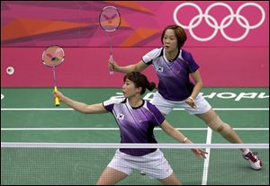 South Korea's Kim Min-jung, left, and Ha Jung-eun play against South Africa's Michelle Edwards and Annari Viljoen in a women's doubles badminton match. The South Korean players were disqualified for deliberately trying to lose.