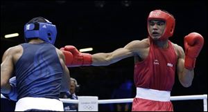 India's Krishan Vikas, right, fights United States' Errol Spence during a men's welterweight 69-kg preliminary boxing match at the 2012 Summer Olympics on Friday.