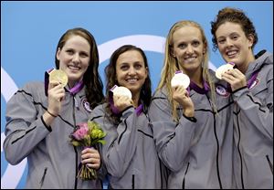 U.S. women's 4 x 100-meter medley relay team members from left, Missy Franklin, Rebecca Soni, Dana Vollmer, and Alison Schmitt hold their gold medals after their victory.