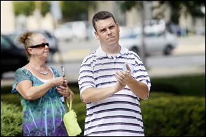 Nathan Eberly of Bowling Green applauds James Gray, the Libertarian vice presidential candidate. Mr. Eberly was among about 15 people who gathered Saturday at the Lucas County Courthouse as Mr. Gray endorsed the 'Freedom to Marry' amendment.