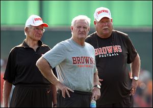 New Browns owner Jimmy Haslam III, center, is flanked by his father, James Haslam II, left, and team president Mike Holmgren during Friday's practice.