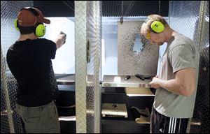 Shane Jamerson of Rossford, left, and Alex Thomasson use the shooting range at Cleland’s Outdoor World.