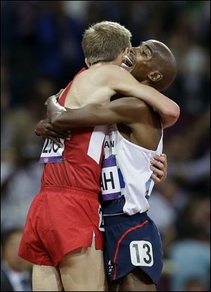 Britain's Mo Farah, right, embraces the United States' Galen Rupp after winning gold in the men's 10,000-meter final. The two are training partners.