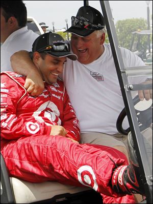 Juan Pablo Montoya, left, receives a hug after winning the pole for today's race in Long Pond, Pa.