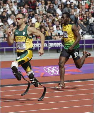 South Africa's Oscar Pistorius, left, and Jamaica's Rusheen McDonald compete in a men's 400-meter heat during the athletics in the Olympic Stadium at the 2012 Summer Olympics.