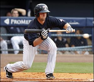 Mud Hens catcher Bryan Holaday looks to bunt against  the Rochester Red Wings in the third inning Saturday night at Fifth Third Field. The Mud Hens' offense struggled once again, producing just two hits in a 6-0 loss.
