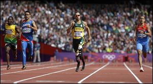 South Africa's Oscar Pistorius leads Jamaica's Rusheen McDonald in a 400-meter heat at the Olympics. Pistorius runs on carbon-fiber blades after having his lower legs amputated as a child.
