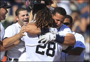 Miguel Cabrera gets a hug from Prince Fielder after his two-run home run in the 10th inning capped a rally from an 8-5 deficit.
