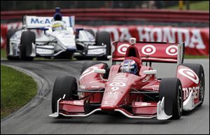 Scott Dixon leads a pack of cars during the IndyCar Series Honda Indy 200 auto race at Mid-Ohio Sports Car Course on Sunday  in Lexington, Ohio. Dixon took the lead for good by passing Will Power on pit row on the 57th lap and then held on for his fourth IndyCar title in the last six years at Mid-Ohio.