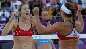Kerri Walsh Jennings, left, and Misty May-Treanor, right, react during their quarterfinal women's beach volleyball match against Italy Sunday.