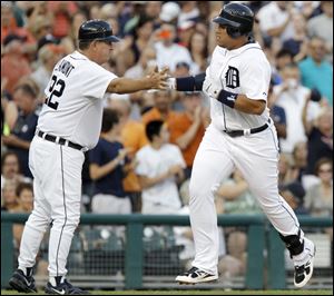 Detroit’s Miguel Cabrera is congratulated by third base coach Gene
Lamont after hitting a solo home run in the fourth inning.