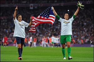 Carli Lloyd, left, and Hope Solo celebrate Team USA's 2-1's victory over Japan to capture an Olympic gold in women's soccer. Lloyd scored both goals for the United States.