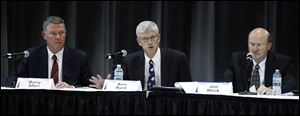 From left, Barry Allen, Ken Byrd, and Jon Hook of FirstEnergy speak during a meeting Thursday night. The meeting included representatives of the Nuclear Regulatory Commission and First Energy who discussed root cause for the shield building cracking at Davis-Besse and plans to fix the situation.
