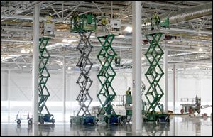 Workers prep the ceiling at the new body shop. Once Liberty production ends, full production won't resume until second-quarter 2013.