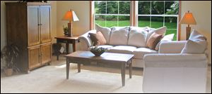 The great room’s ceiling and windows are framed in attractive natural oak.
