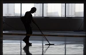 A Jeep worker prepares the floor at Chrysler's new 267,000-square-foot body shop.