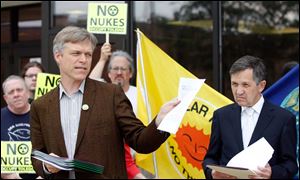 Kevin Kamps of Radioactive Waste Watchdog, left, and U.S. Rep. Dennis Kucinich, right, speak in opposition to the 20-year license extension proposed for the Davis-Besse nuclear plant.