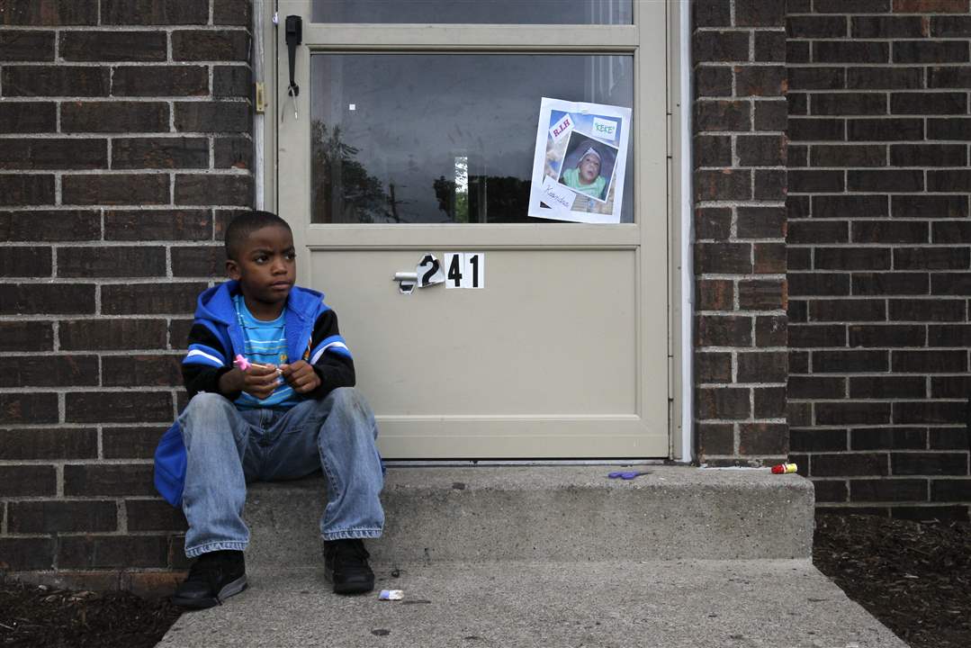 Jaivon-Starks-6-sits-near-a-homemade