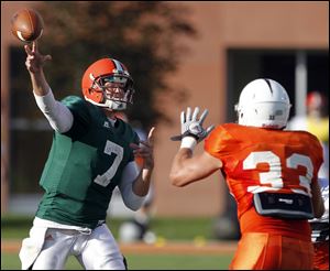 QB Matt Schilz gets a pass over an onrushing defender. Schilz had a four-yard score to tight end Clay Rolf.
