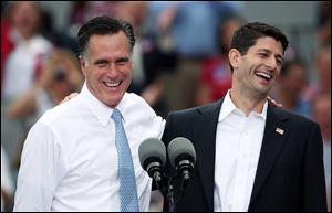 Republican presidential candidate, former Massachusetts Gov. Mitt Romney (L) jokes with Rep. Paul Ryan (R-WI) (R) after announcing him as the 